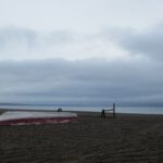 A boat resting on the beach on a cloudy summer day in Gambell, Alaska.