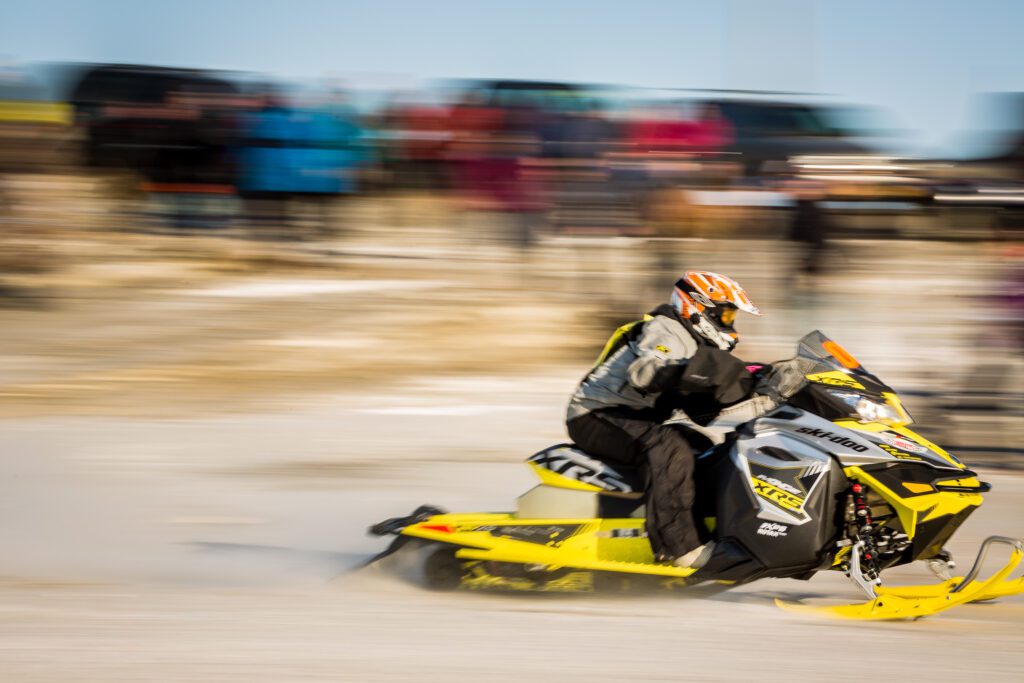 A snowmachine rider screams past the starting line of the Nome-Golovin Snowmachine Race.