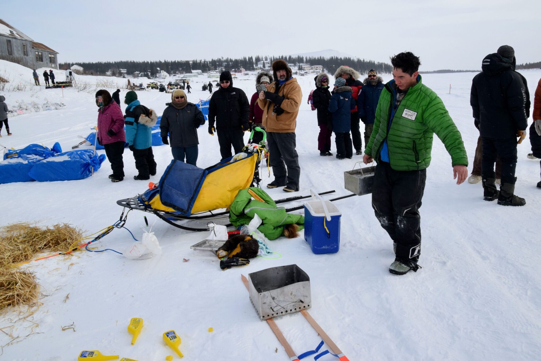 a musher brings water to his dog team