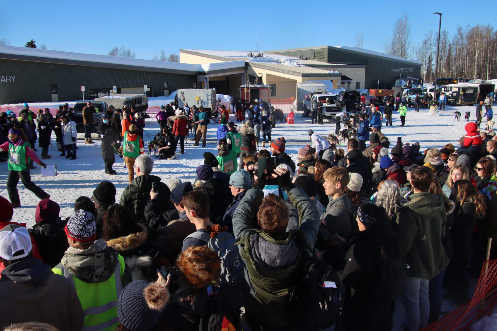 A bunch of people near a dog yard