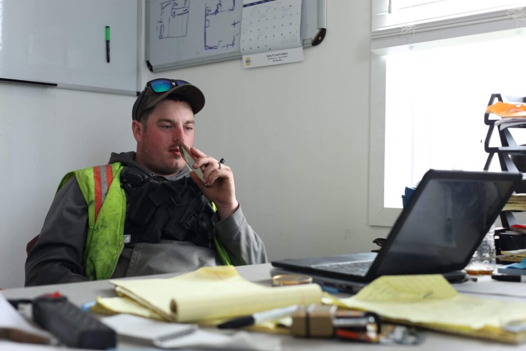 Dustin Scalisi takes a moment to read emails in his office between fielding phone calls. Ben Townsend photo.