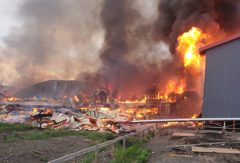 Fire begins to spread from Stebbins School to a nearby housing unit. Photo courtesy of George K Dan.