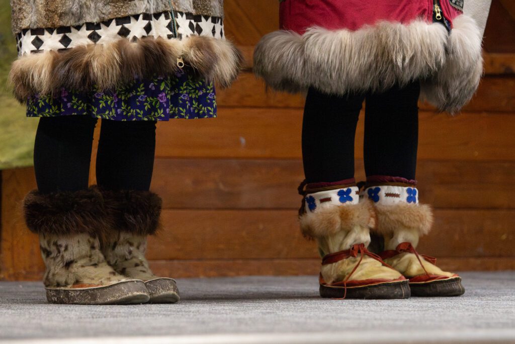 Victoria Gray and Charity Lewis stand on stage in traditional mukluks made from seal. Ben Townsend photo.