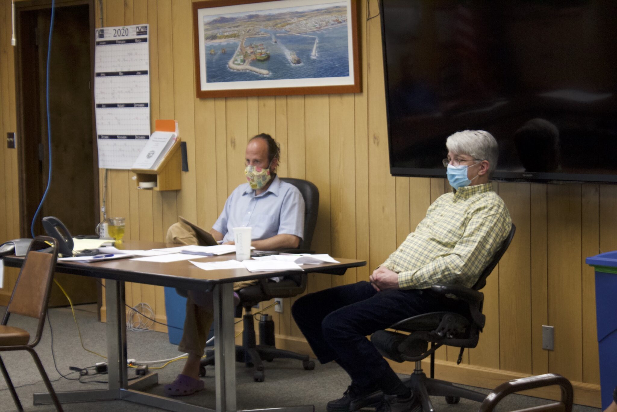 Nome's City Clerk Bryant Hammond and City Manager Glenn Steckman wear face masks during a regular Nome City Council meeting. Photo from Emily Hofstaedter, KNOM (2020).