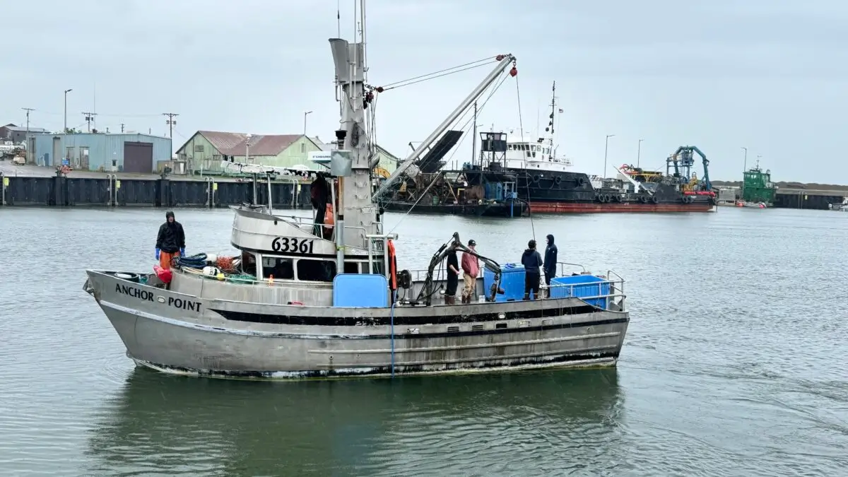 Crew of The Anchor Point gather at the back of the crabbing boat. Sarah Swartz photo.