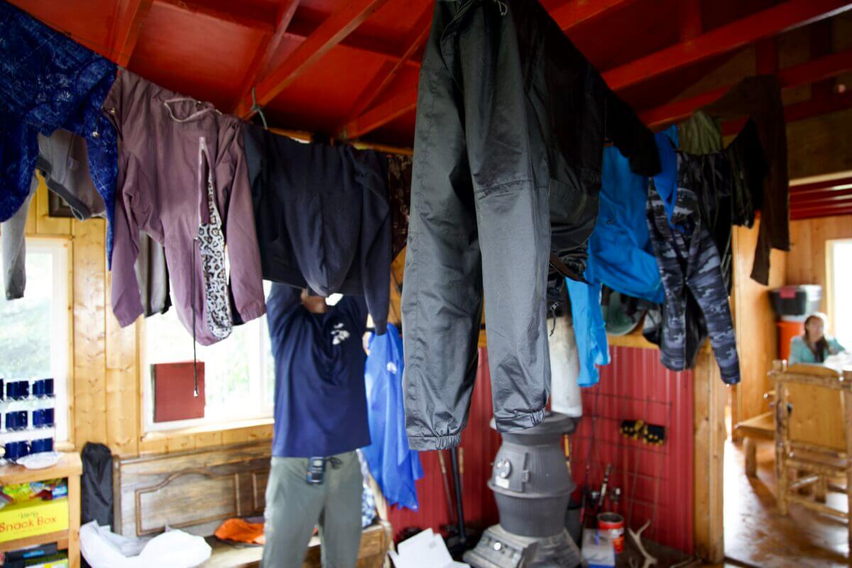 Clothes dry from recently installed clotheslines in the ceiling after a morning hike at Camp CRAVE. Ben Townsend photo.