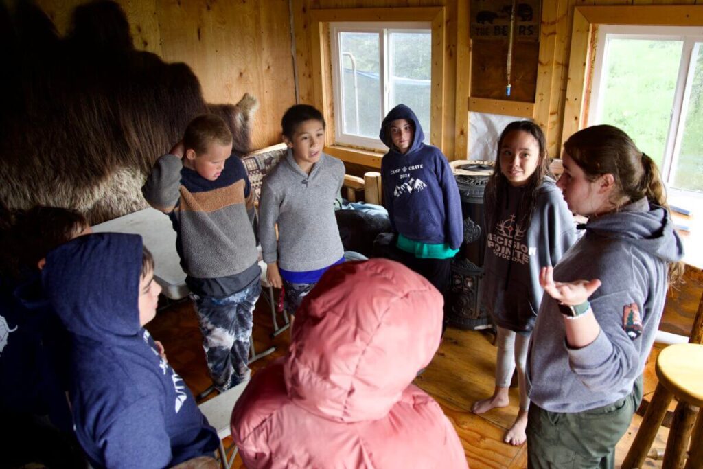 National Park Service Park Ranger Tori Crawford instructs a group of children at Camp Crave on how to play a game. Ben Townsend photo.