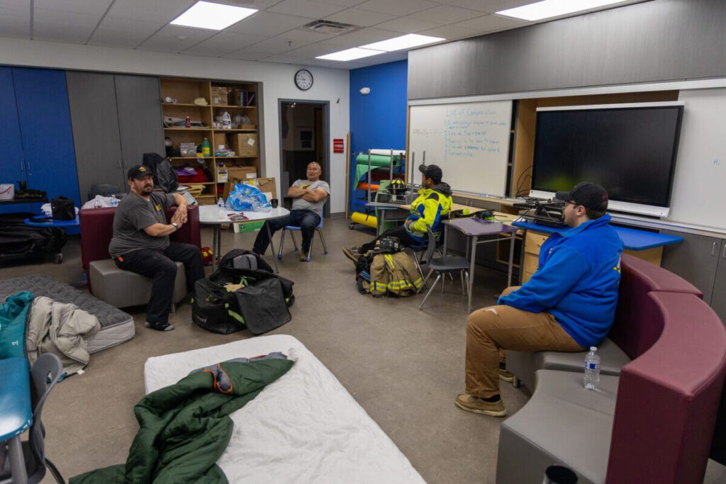 Volunteers from the Nome Volunteer Fire Department rest in the Shishmaref School the morning after the fire. Ben Townsend photo.