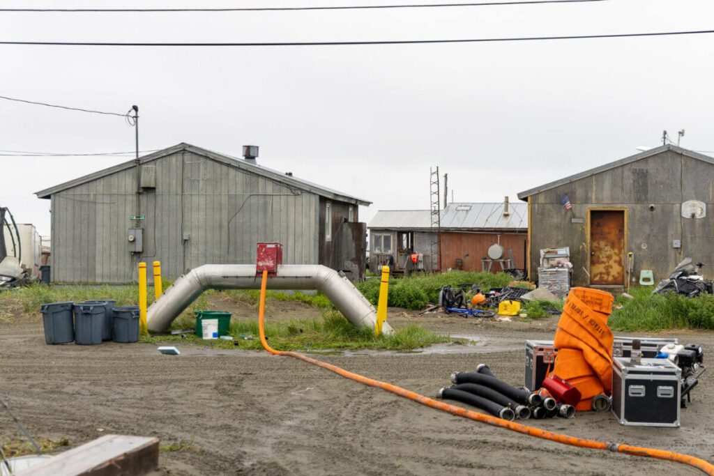 A water line was tapped to fill large plastic bins for firefighting. Equipment from Nome Volunteer Fire Department rests in the foreground. Ben Townsend photo.