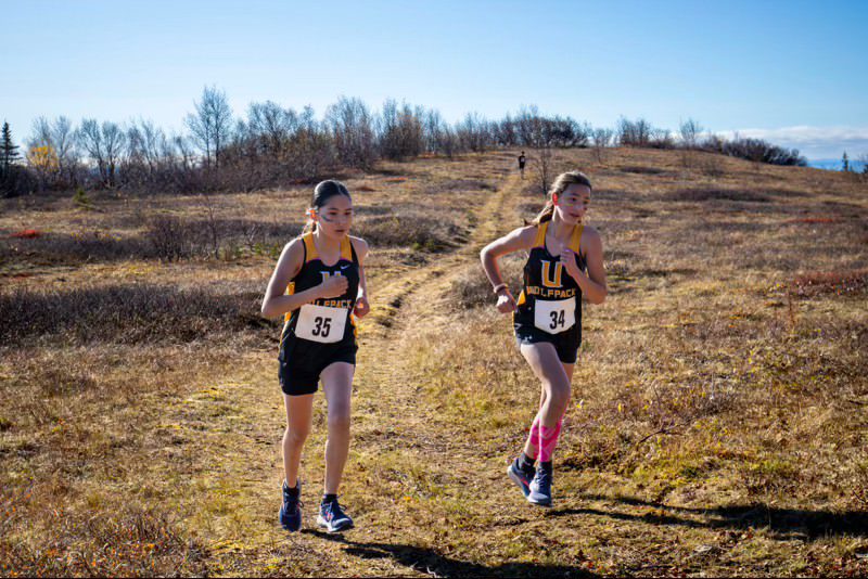 Turi Busk runs alongside Alex Ivanoff at the Qamuuqhin Hill Trails in Unalakleet Photo courtesy of Thurman Jack. 