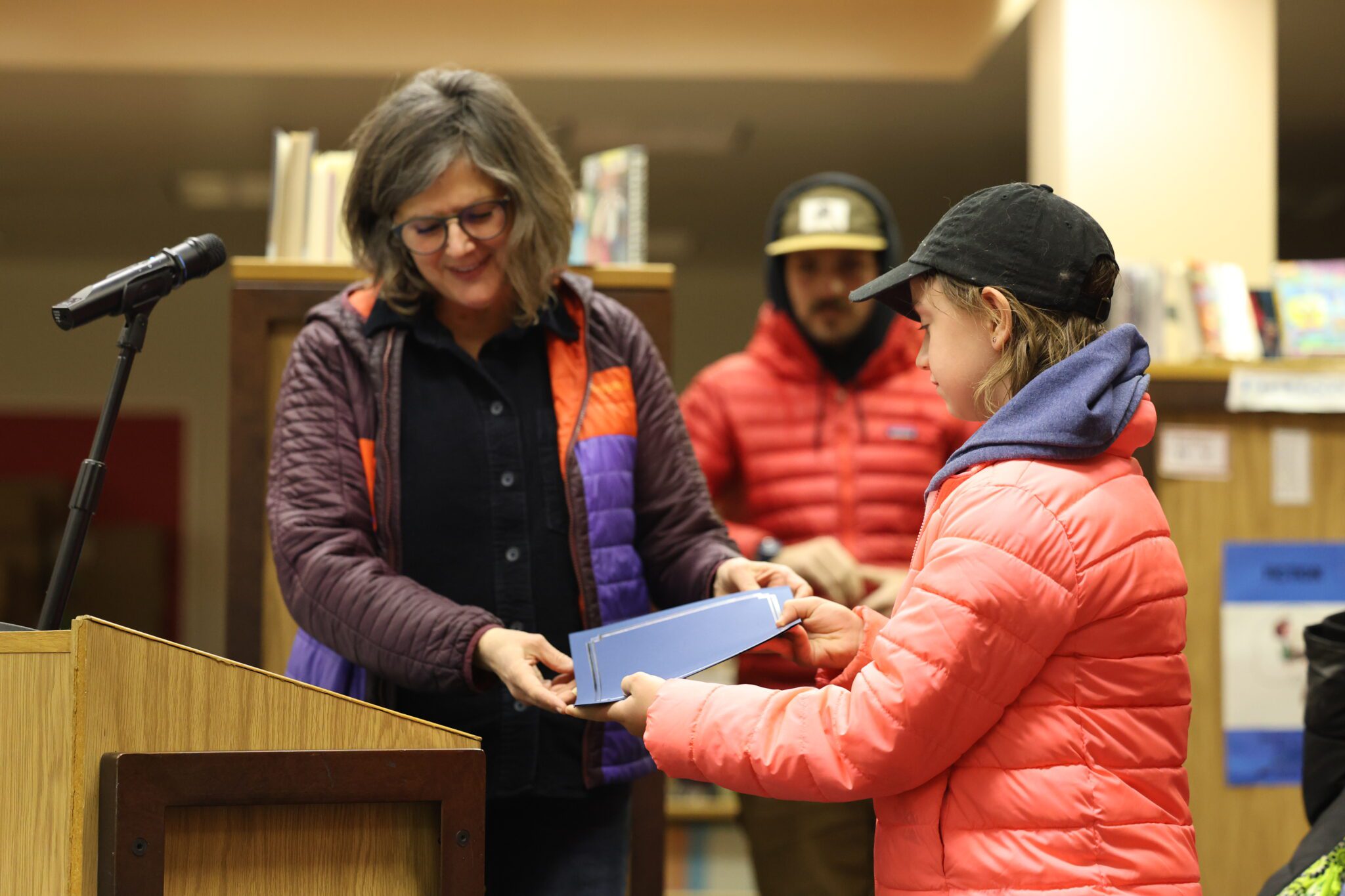 Teagan Olson receives a certificate from Nome-Beltz Principal Teriscovkya Smith. Ben Townsend photo.