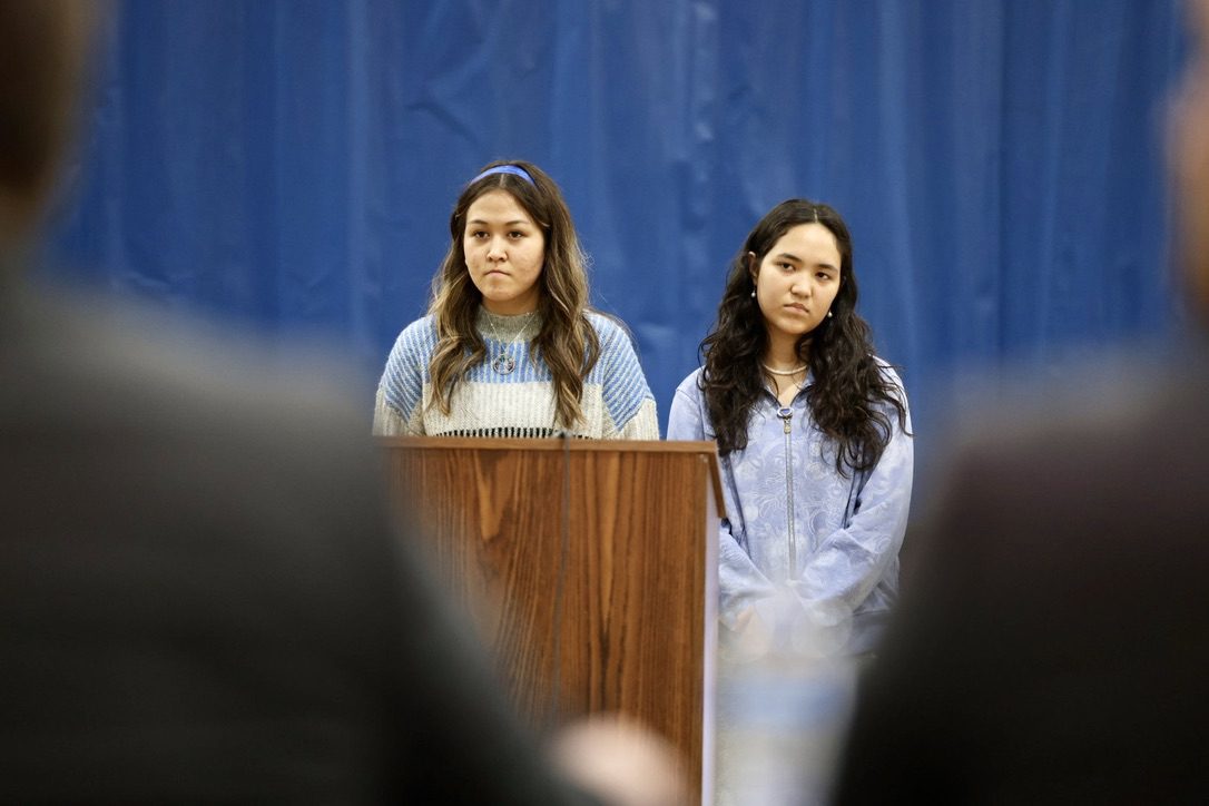 Angela Olmeadalina asks a question, flanked by Sara James. 