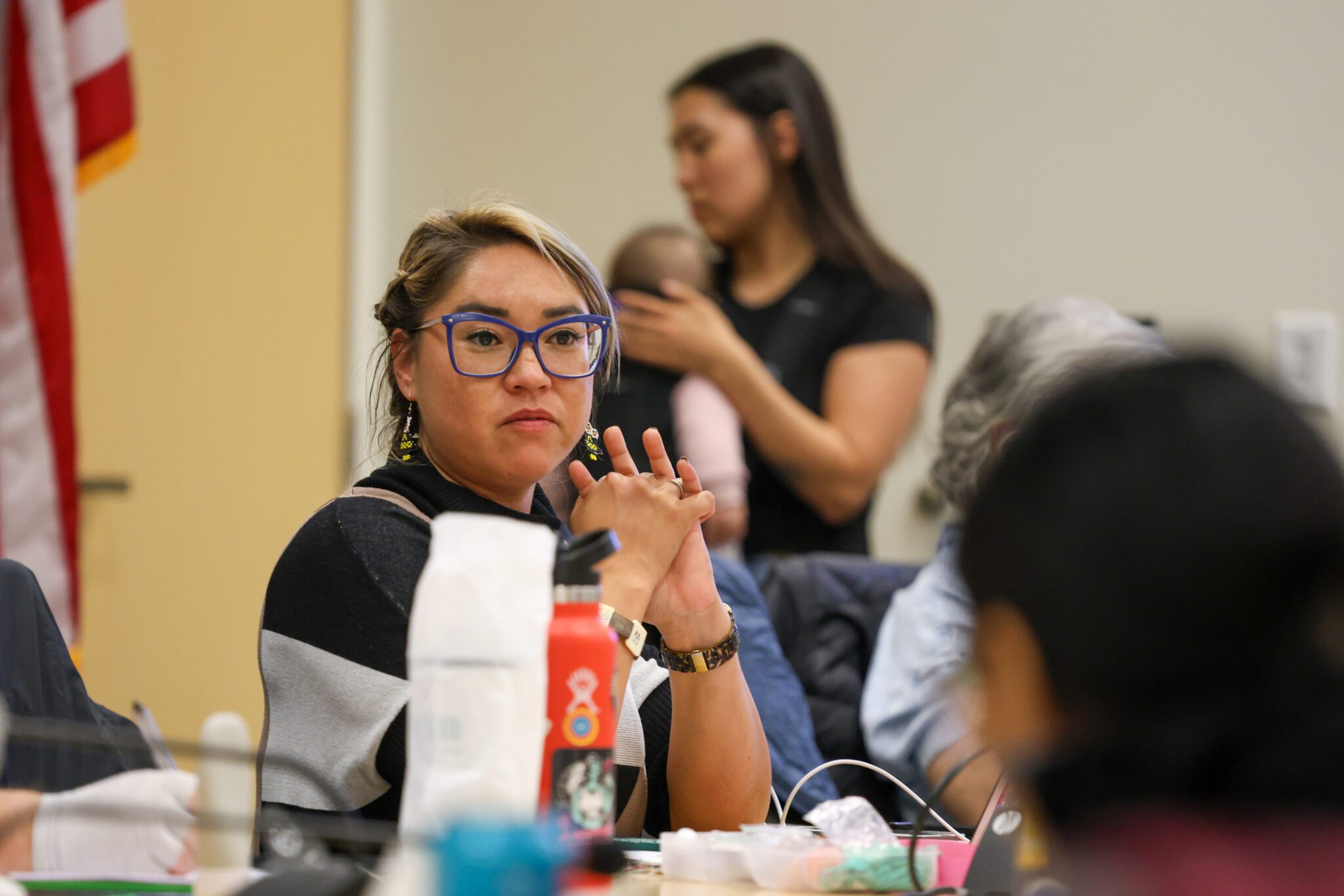 Deilah Johnson addresses the group as Jasmine Jemewouk paces with her newborn in the background. Ben Townsend photo.