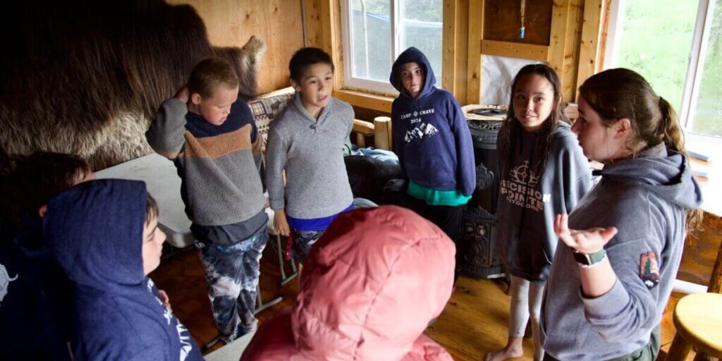 National Park Service Park Ranger Tori Crawford instructs a group of children at Camp Crave on how to play a game. Ben Townsend photo.