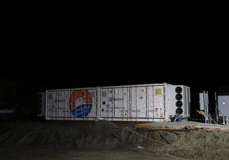 Two containers packed with batteries rest near a new concrete pad at Nome Joint Utility System's powerplant. Ben Townsend photo. 