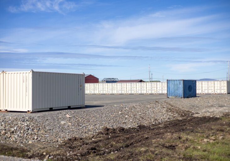 A blue shipping container between two rows of tan shipping containers at Burmeister Leasing & Landscaping, LLC's new self-storage facility. Ben Townsend photo.