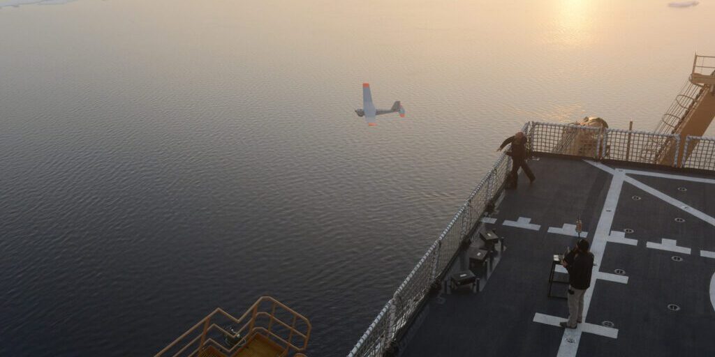 John Ferguson and Chris Thompson, Unmanned Aircraft System operators for AeroVironment, release a Puma All Environment UAS from the flight deck of the Coast Guard Cutter Healy during an exercise in the Arctic Aug. 18, 2014. The Coast Guard Research and Development Center and the National Oceanic and Atmospherc Administration evaluated the UAS for use in tracking a simulated oil spill during the exercise. (Coast Guard photo by Petty Officer 1st Class Shawn Eggert)