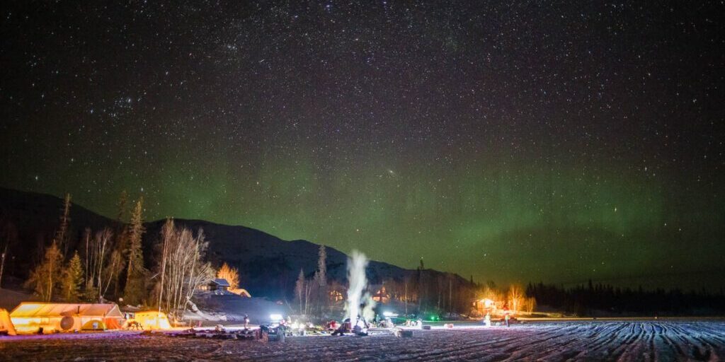 The aurora borealis dances over the dog lot at Finger Lake checkpoint.