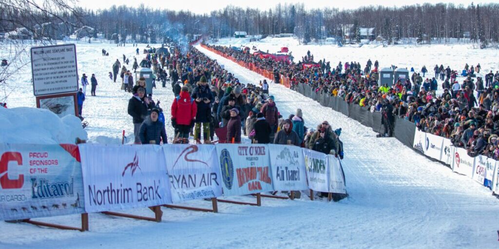 Race fans line both sides of the Iditarod race chute in Willow on March 5, 2023.