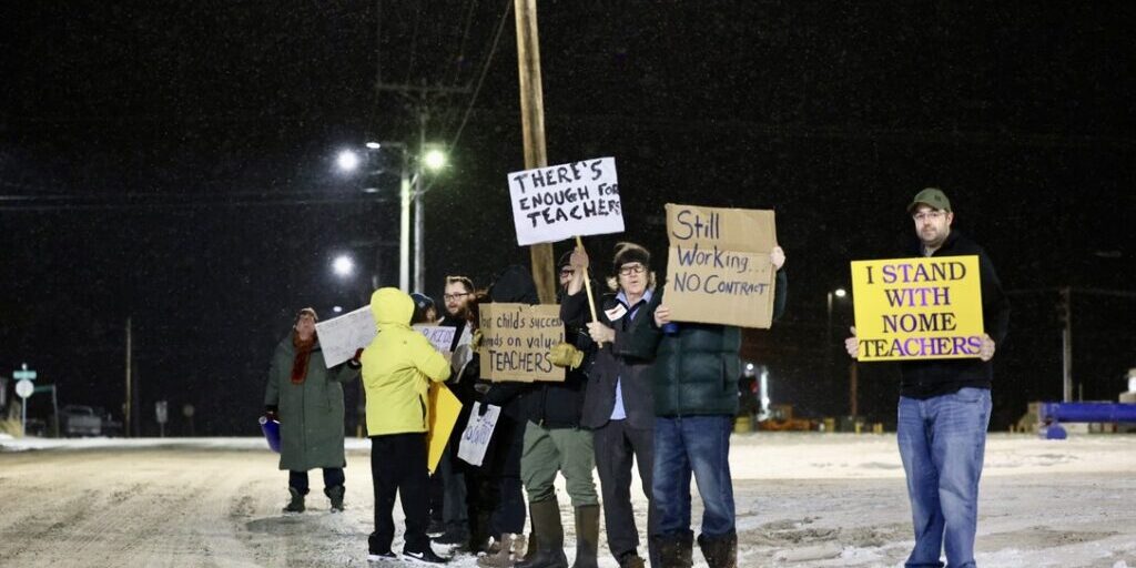 Teachers hold signs in front of Nome Elementary School while parents drop off their students in the morning. Ben Townsend photo. 