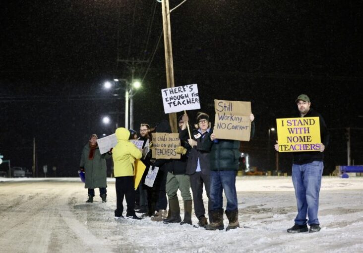 Teachers hold signs in front of Nome Elementary School while parents drop off their students in the morning. Ben Townsend photo. 