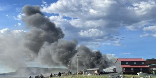 A fire at Stebbins School causes a large plume of dark grey smoke to rise into the air. Pamela Pete photo from Facebook.