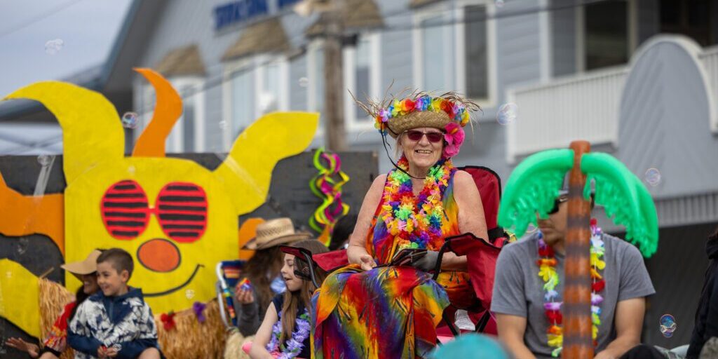 Cussy Kauer smiles while sitting on a midnight sun themed float at 2025's Midnight Sun Parade. Ben Townsend photo.