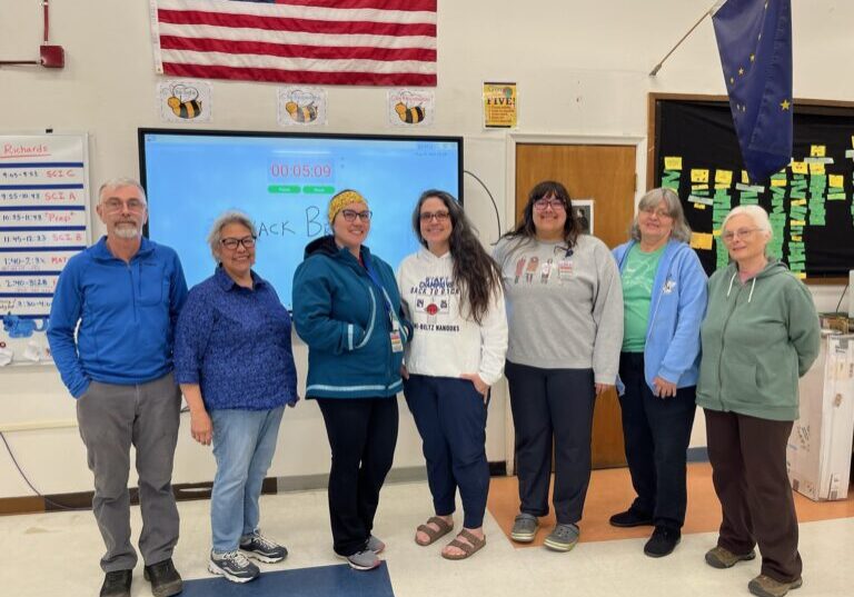 Nome local artists line up for a photo, from left to right: Ken Hughes, Josie Bourdon, Katie Hannon, Crystal Lie, Maggie Miller, Ginny Emmons and Chris Rowe. photo credit: Lisa Leeper, Nome Public Schools.
