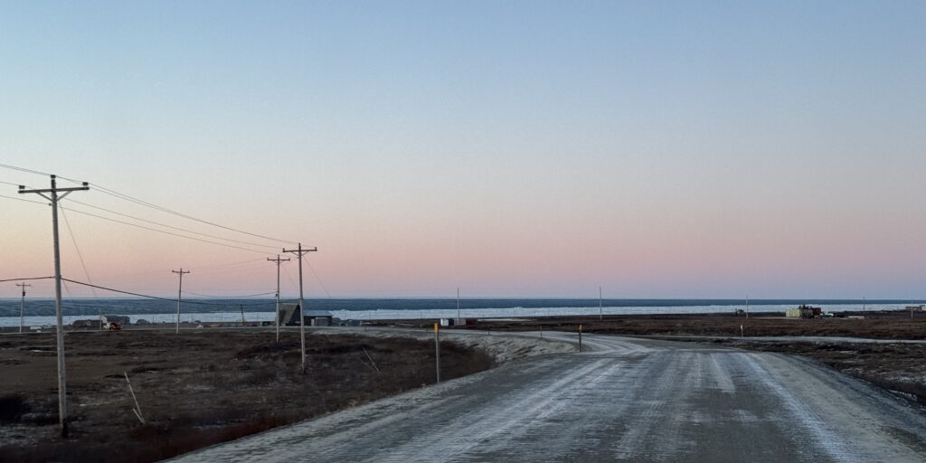 Brown, snowless tundra surrounds Beam Road in Nome as a thin layer of shorefast ice clings to the shore. Ben Townsend photo.