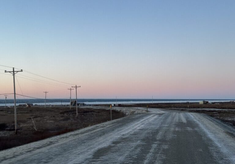 Brown, snowless tundra surrounds Beam Road in Nome as a thin layer of shorefast ice clings to the shore. Ben Townsend photo.