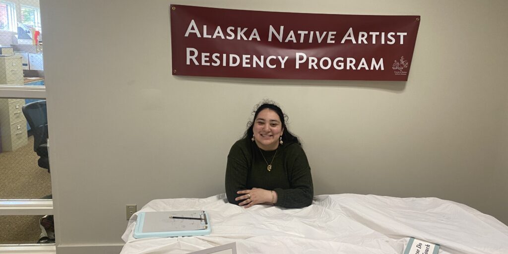 Lisa Lynch sits at a table set up at the Sheldon Jackson Museum. Photo courtesy of Lisa Lynch. 