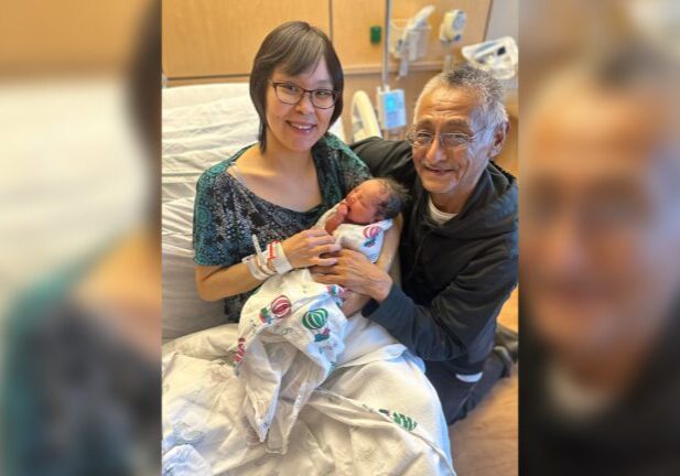 Danita Douglas and Dwayne Charles embrace their hours-old daughter Olga Margaret Douglas-Charles. Photo courtesy of Norton Sound Health Corporation.