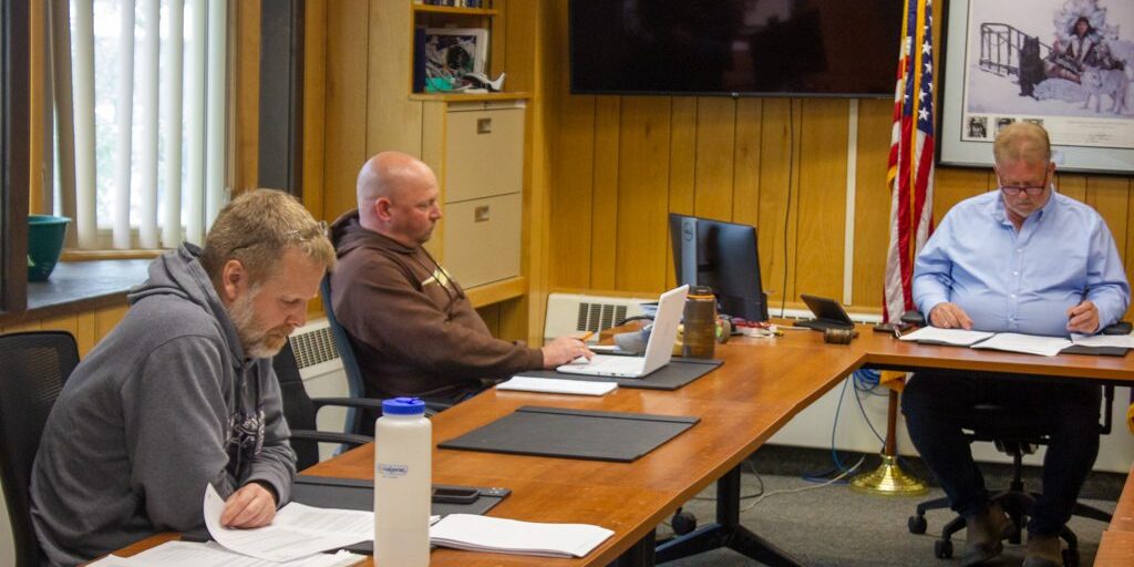 Council Members Scot Henderson (left) and Adam Martinson (center) and Mayor John Handeland (right) at the June 13 Nome Common Council meeting. Photo by Sean Milligan, KNOM (2022).