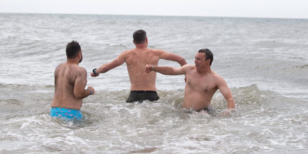 Polar Plunge participants were forced to quickly enter the water as tall waves crashed into them. Ben Townsend photo.