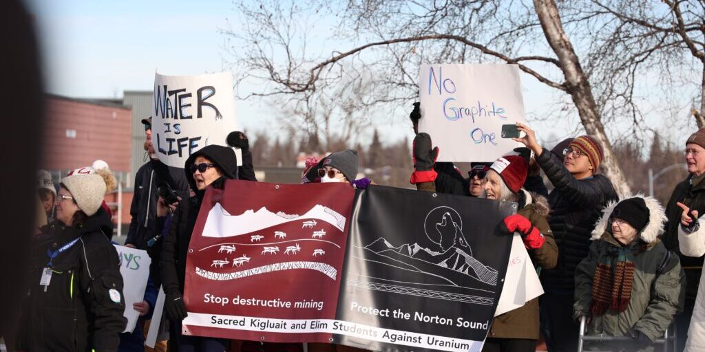 Protestors hold signs on Cordova Street in Anchorage during the Iditarod's Ceremonial Start Saturday, March 1, 2025. Janice Homekingkeo photo.
