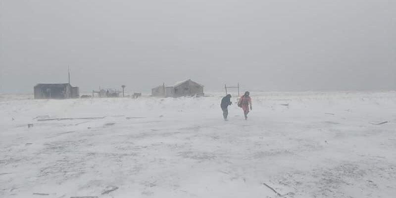 Petty Officer 1st Class David McClure, an aviation survival technician stationed in Kodiak, Alaska, rescues a stranded hunter on the Punuk Islands, near St. Lawrence Island, Alaska, Nov. 29, 2018. The two hunters were located and safely transported to Nome for further care. U.S. Coast Guard photo by Lt. Daniel Beshoar.