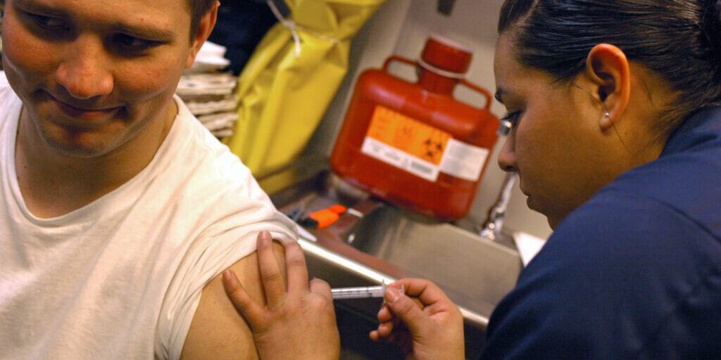 070406-N-5627R-326
SOUTH CHINA SEA (Apr. 6, 2007) - Airman Sandra Valdovinos, from Delano, Calif., administers Airman Adam Helton, from Mesa, Ariz., a Hepatitis B vaccine for his annual birth month recall (BMR) aboard the aircraft carrier USS Ronald Reagan (CVN 76). BMR's are given every month to make sure Sailors are updated on their shots. The Ronald Reagan Carrier Strike Group (CSG) is underway on a surge deployment in support of U.S. military operations in the Western Pacific. U.S. Navy Photo by Mass Communication Specialist 3rd Class Joanna M. Rippee (RELEASED)